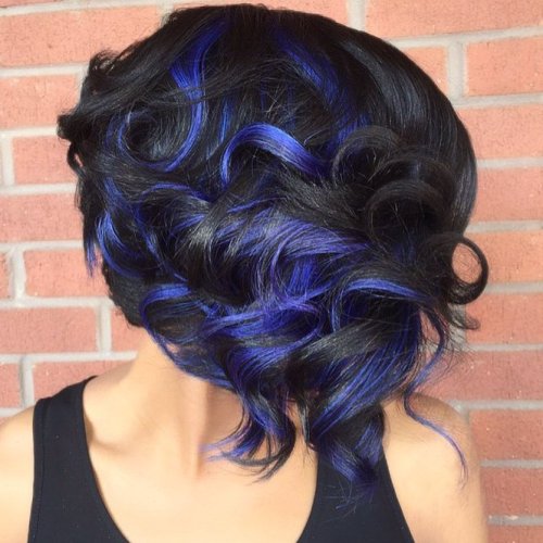 black curly hairstyle with blue highlights